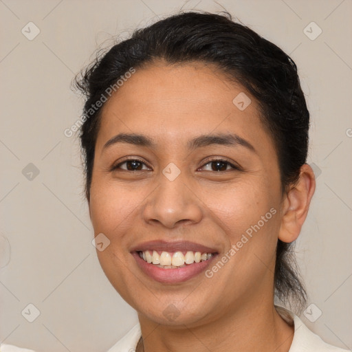 Joyful latino young-adult female with medium  brown hair and brown eyes