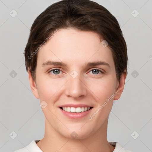 Joyful white young-adult female with short  brown hair and grey eyes