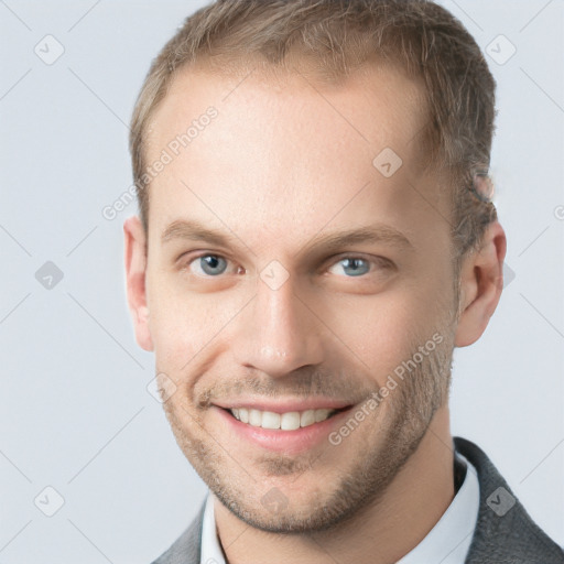 Joyful white young-adult male with short  brown hair and grey eyes