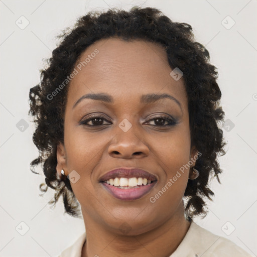 Joyful black young-adult female with long  brown hair and brown eyes