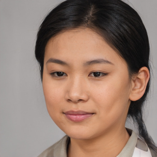 Joyful asian young-adult female with medium  brown hair and brown eyes