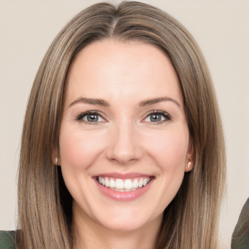 Joyful white young-adult female with long  brown hair and brown eyes