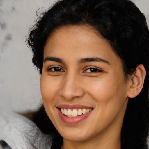 Joyful latino young-adult female with medium  brown hair and brown eyes