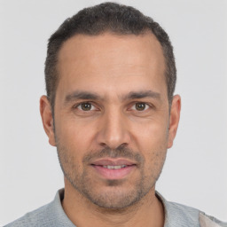 Joyful white adult male with short  brown hair and brown eyes