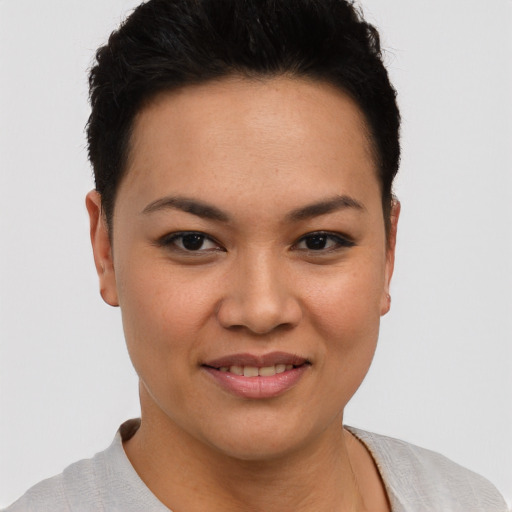 Joyful latino young-adult female with short  brown hair and brown eyes