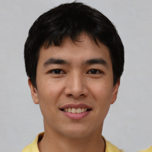 Joyful asian young-adult male with short  brown hair and brown eyes