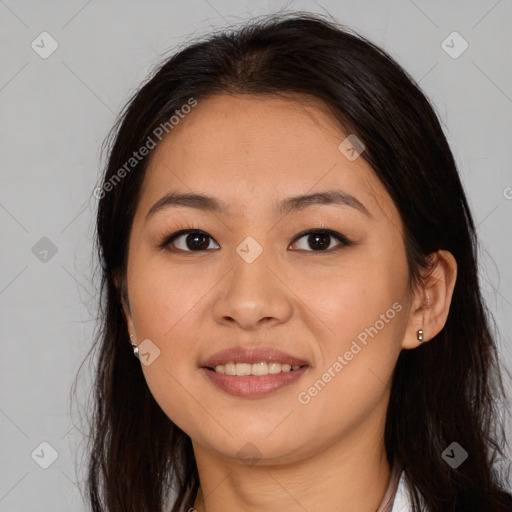 Joyful latino young-adult female with long  brown hair and brown eyes