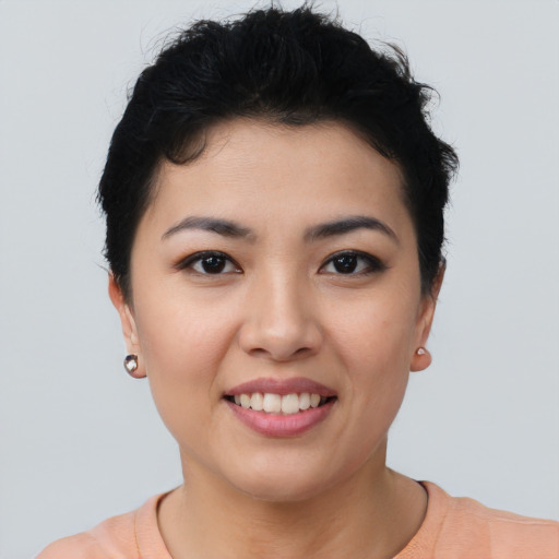 Joyful asian young-adult female with short  brown hair and brown eyes