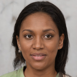 Joyful black young-adult female with medium  brown hair and brown eyes