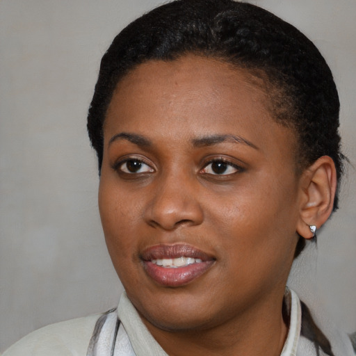 Joyful black young-adult female with medium  black hair and brown eyes