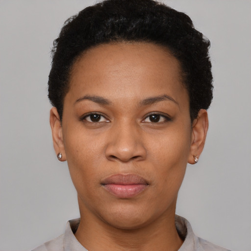 Joyful latino young-adult female with short  black hair and brown eyes
