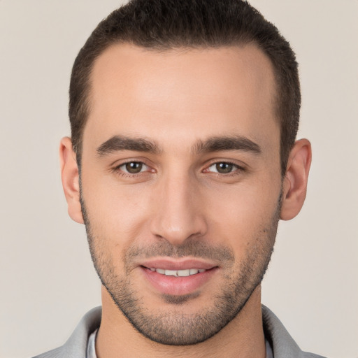 Joyful white young-adult male with short  brown hair and brown eyes