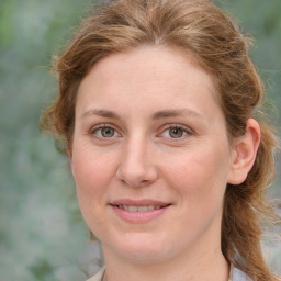 Joyful white young-adult female with medium  brown hair and green eyes