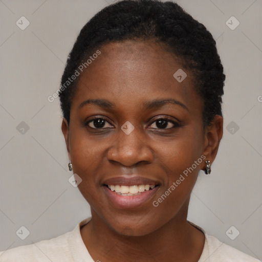 Joyful black young-adult female with short  black hair and brown eyes