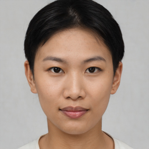 Joyful asian young-adult female with short  brown hair and brown eyes