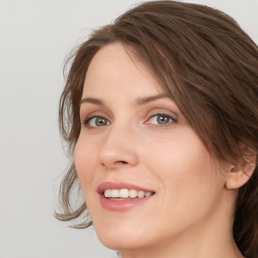 Joyful white young-adult female with medium  brown hair and green eyes