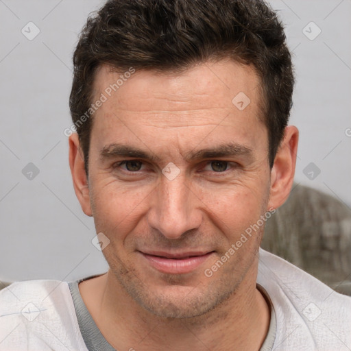 Joyful white adult male with short  brown hair and brown eyes