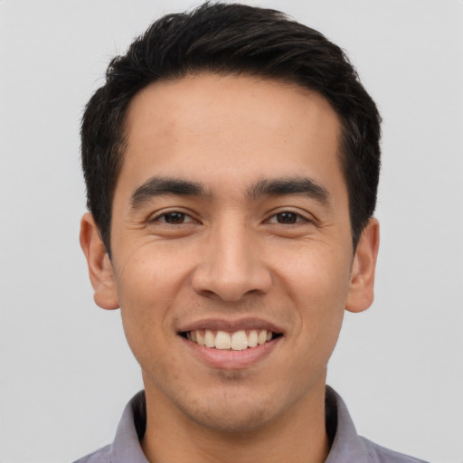 Joyful latino young-adult male with short  black hair and brown eyes