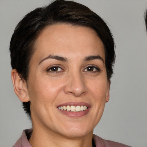 Joyful white adult female with medium  brown hair and brown eyes