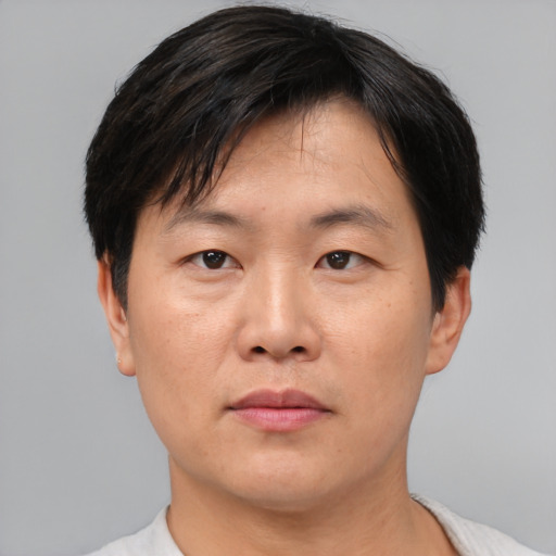Neutral asian adult male with short  black hair and brown eyes