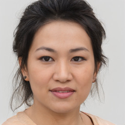 Joyful asian young-adult female with medium  brown hair and brown eyes