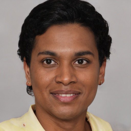 Joyful latino young-adult male with short  brown hair and brown eyes