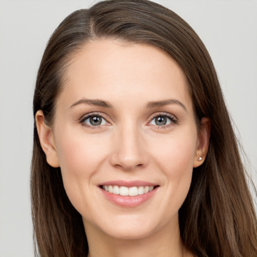 Joyful white young-adult female with long  brown hair and grey eyes