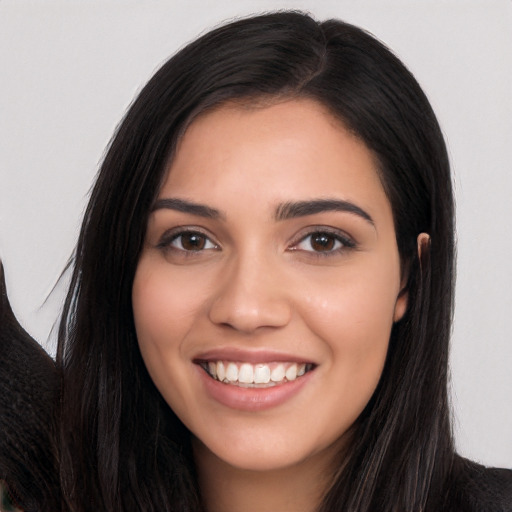 Joyful white young-adult female with long  black hair and brown eyes