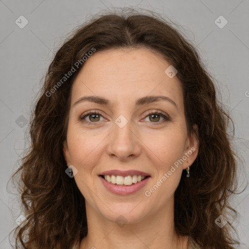 Joyful white adult female with long  brown hair and green eyes