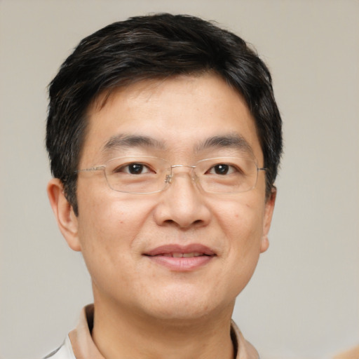 Joyful asian adult male with short  black hair and brown eyes