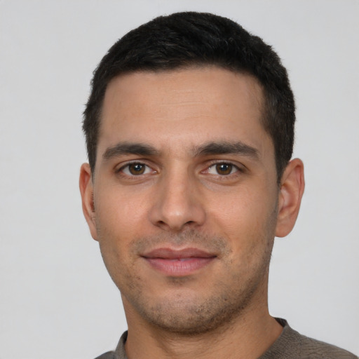 Joyful white young-adult male with short  black hair and brown eyes