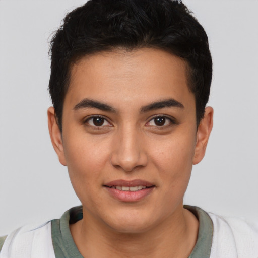 Joyful latino young-adult male with short  brown hair and brown eyes