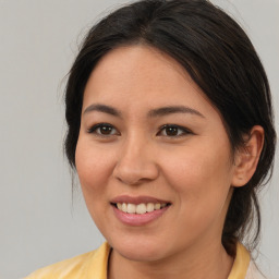 Joyful latino young-adult female with medium  brown hair and brown eyes