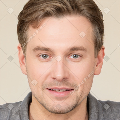 Joyful white young-adult male with short  brown hair and grey eyes