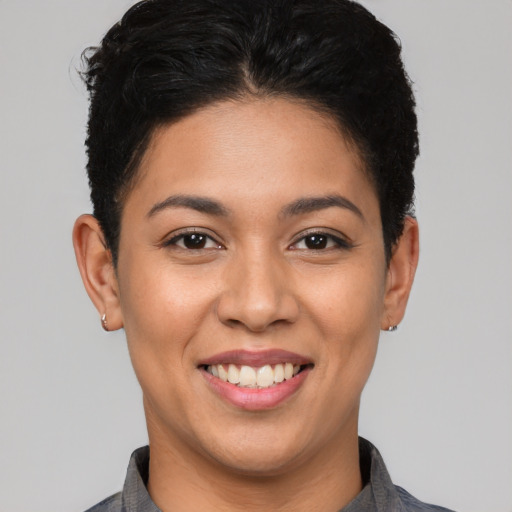 Joyful latino young-adult female with short  brown hair and brown eyes
