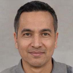 Joyful white adult male with short  black hair and brown eyes