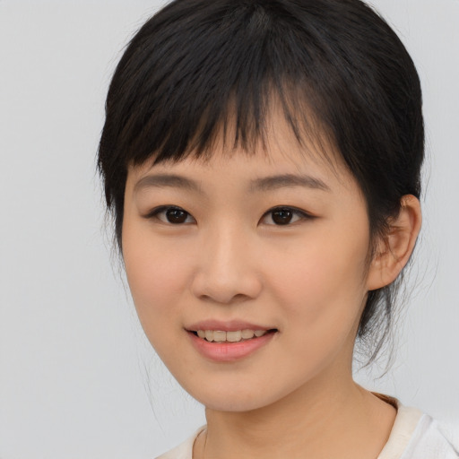 Joyful asian young-adult female with medium  black hair and brown eyes