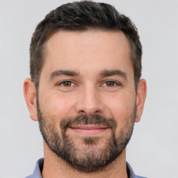 Joyful white adult male with short  brown hair and brown eyes