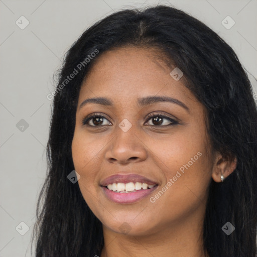 Joyful black young-adult female with long  black hair and brown eyes