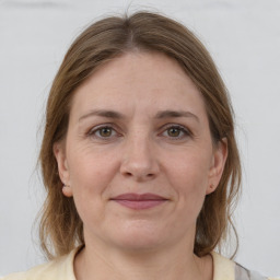 Joyful white adult female with medium  brown hair and grey eyes