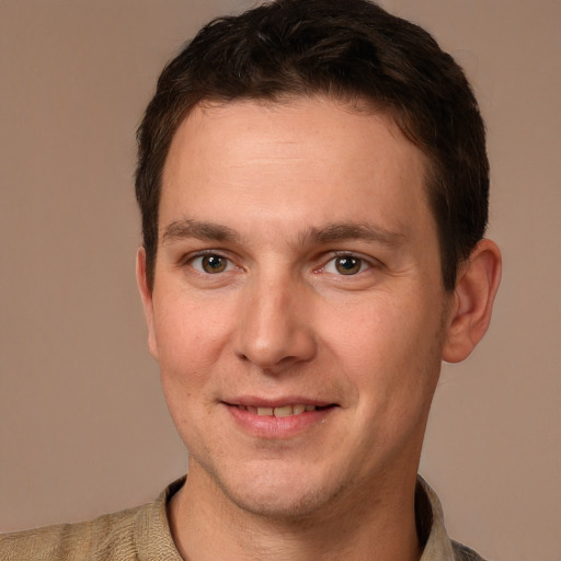 Joyful white young-adult male with short  brown hair and brown eyes