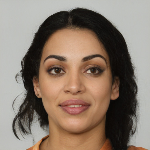 Joyful latino young-adult female with medium  black hair and brown eyes