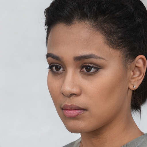 Neutral latino young-adult female with short  black hair and brown eyes