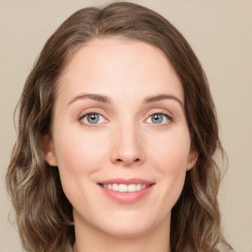 Joyful white young-adult female with medium  brown hair and green eyes