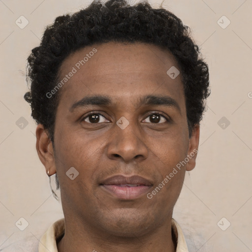 Joyful black young-adult male with short  brown hair and brown eyes