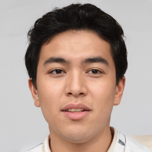 Joyful asian young-adult male with short  black hair and brown eyes
