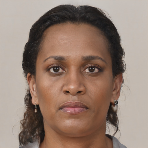 Neutral black young-adult female with medium  brown hair and brown eyes