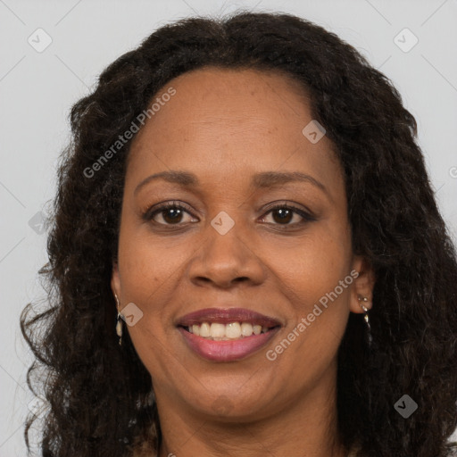 Joyful black adult female with long  brown hair and brown eyes