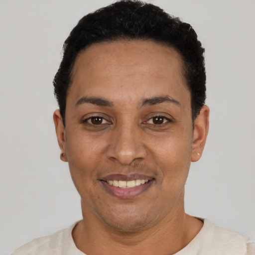 Joyful latino young-adult female with short  black hair and brown eyes