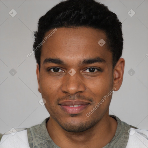 Joyful black young-adult male with short  black hair and brown eyes